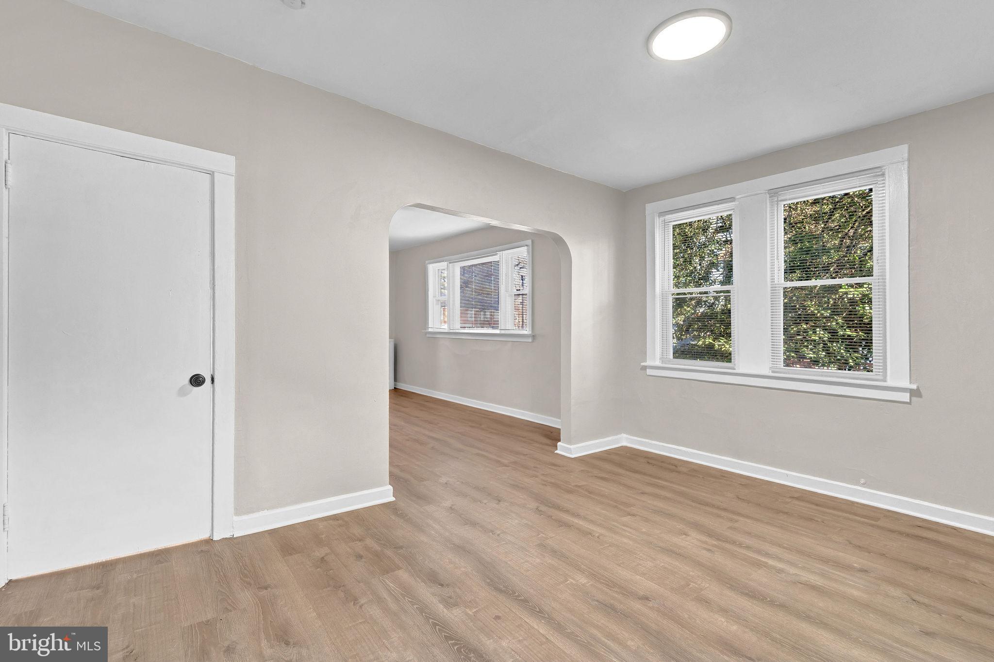 2791 Yorkship Road Camden, NJ 08104 - Photo 10 of 33 an empty room with wooden floor and windows