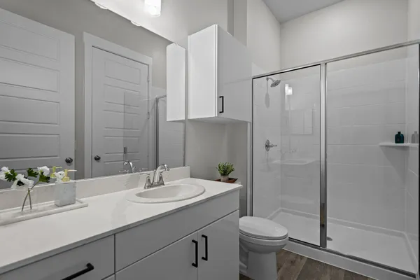 a bathroom with a sink toilet and shower