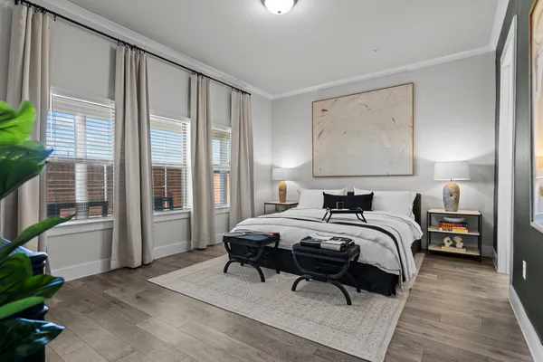 a bedroom with a bed and a large window