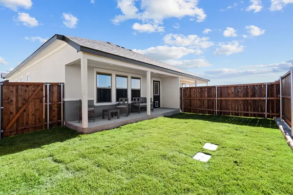 a view of a house with backyard and porch