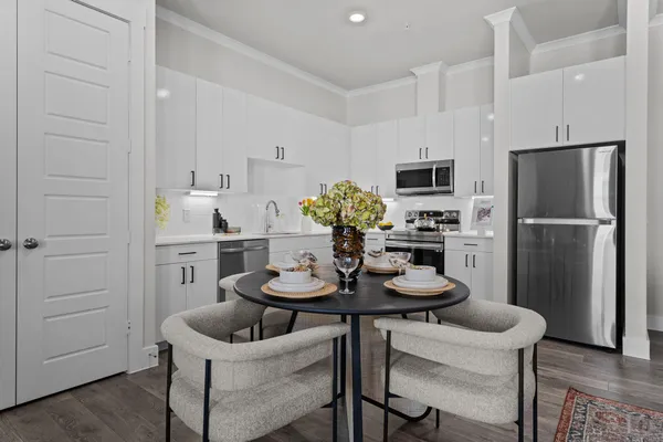 a kitchen with a refrigerator and dining table