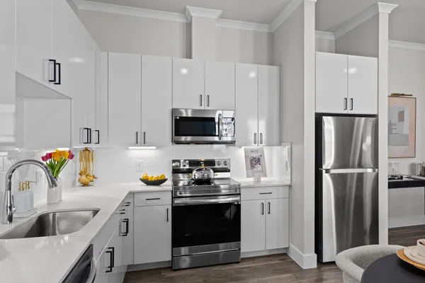 a kitchen with stainless steel appliances a refrigerator sink and microwave