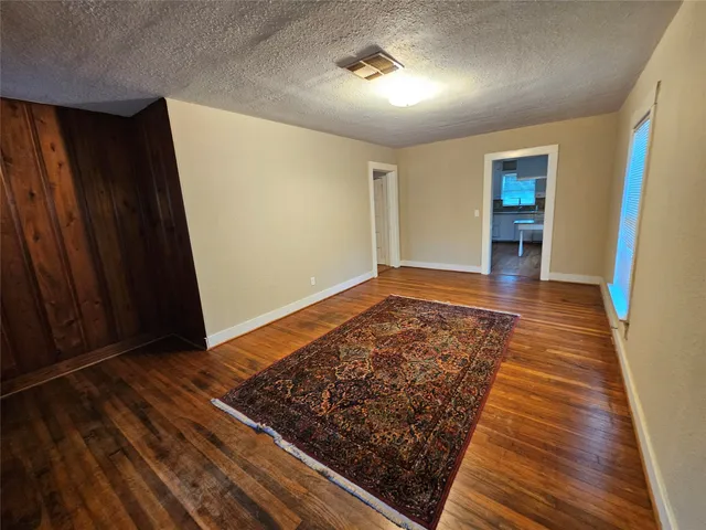 wooden floor in an empty room with a fireplace