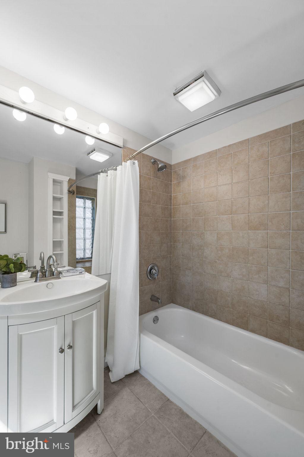 914 15th Street Southeast Washington, DC 20003 - Photo 22 of 37 a bathroom with a sink double vanity mirror and a bathtub