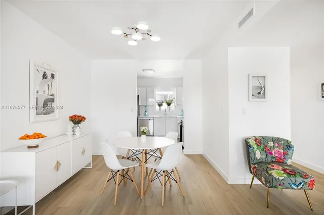 a kitchen with stainless steel appliances a sink cabinets and a wooden floor