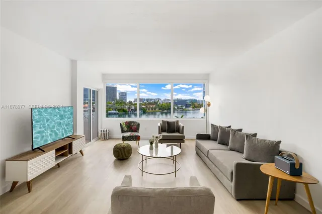 a living room with furniture and a floor to ceiling window