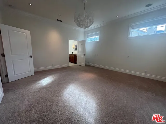 an empty room with windows and entrance