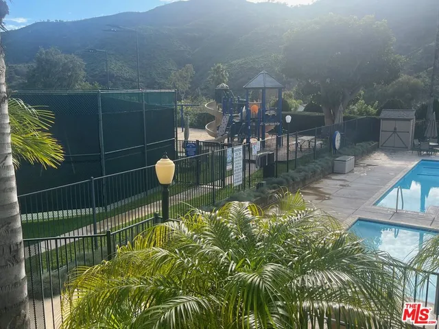a swimming pool with a yard and outdoor seating
