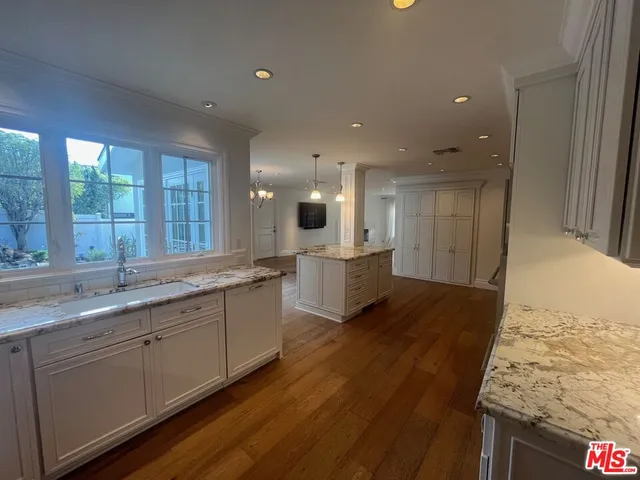 a large kitchen with stainless steel appliances granite countertop a lot of counter space and a sink