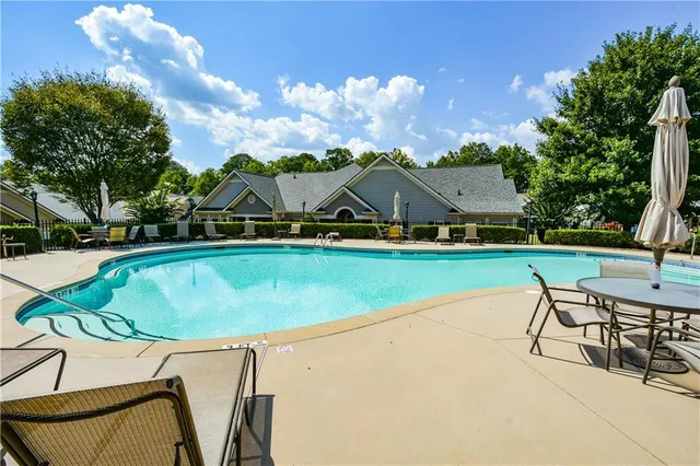 a view of house with outdoor space and view of swimming pool