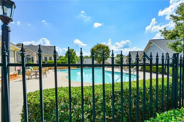 a front view of a house with a yard and potted plants
