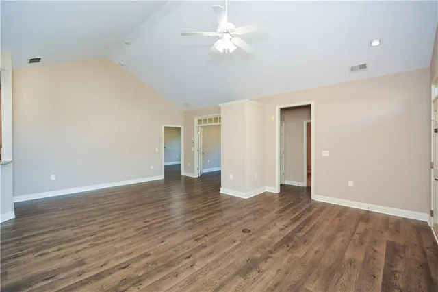 a view of an empty room with wooden floor