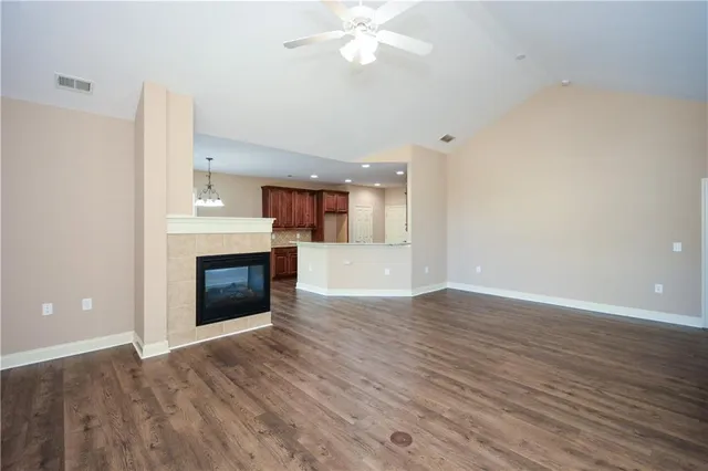 an empty room with wooden floor and fireplace
