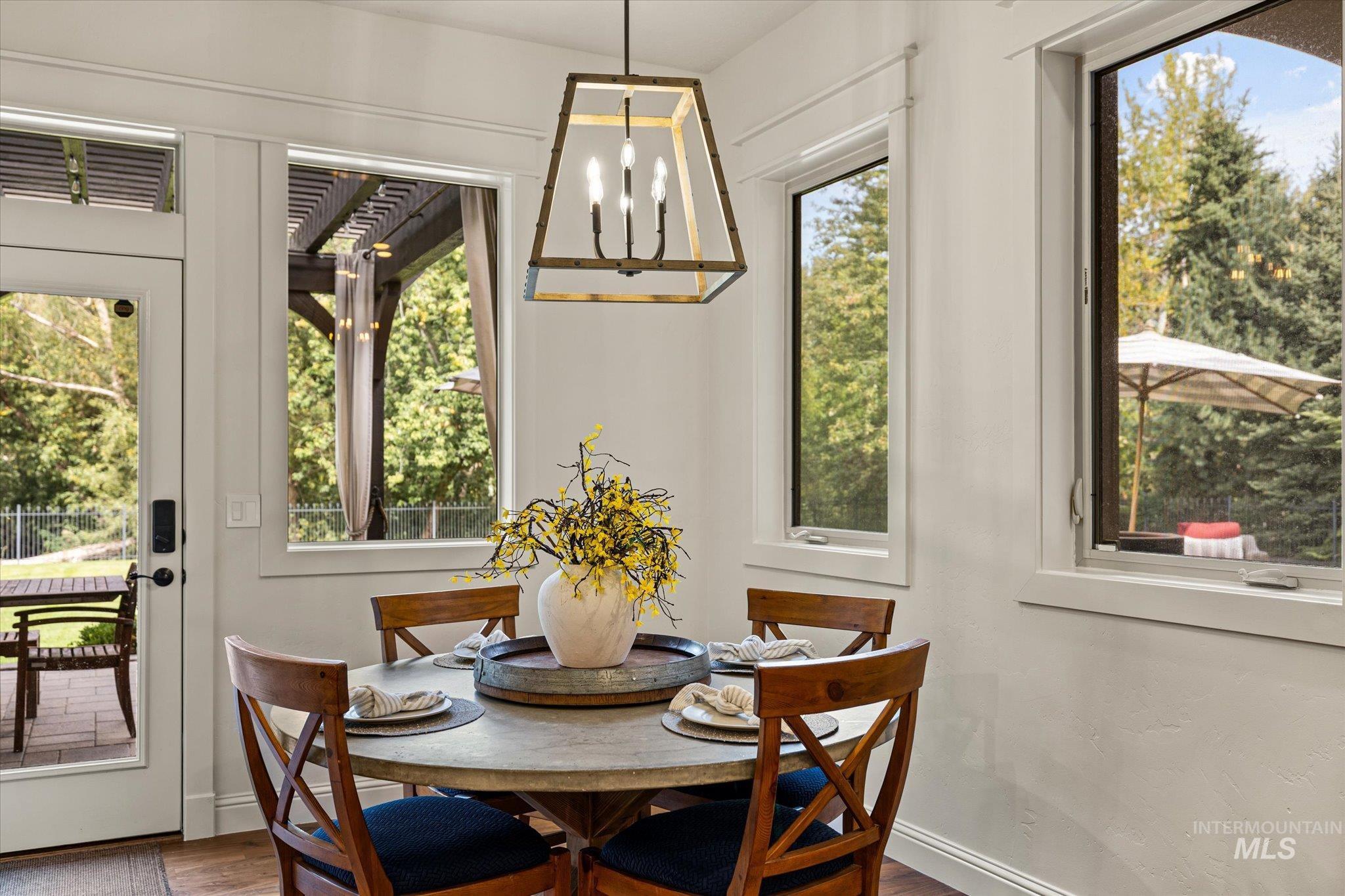 226 East Riversedge Drive Eagle, ID 83616 - Photo 20 of 50 Dining room with a chandelier, healthy amount of natural light, and wood finished floors
