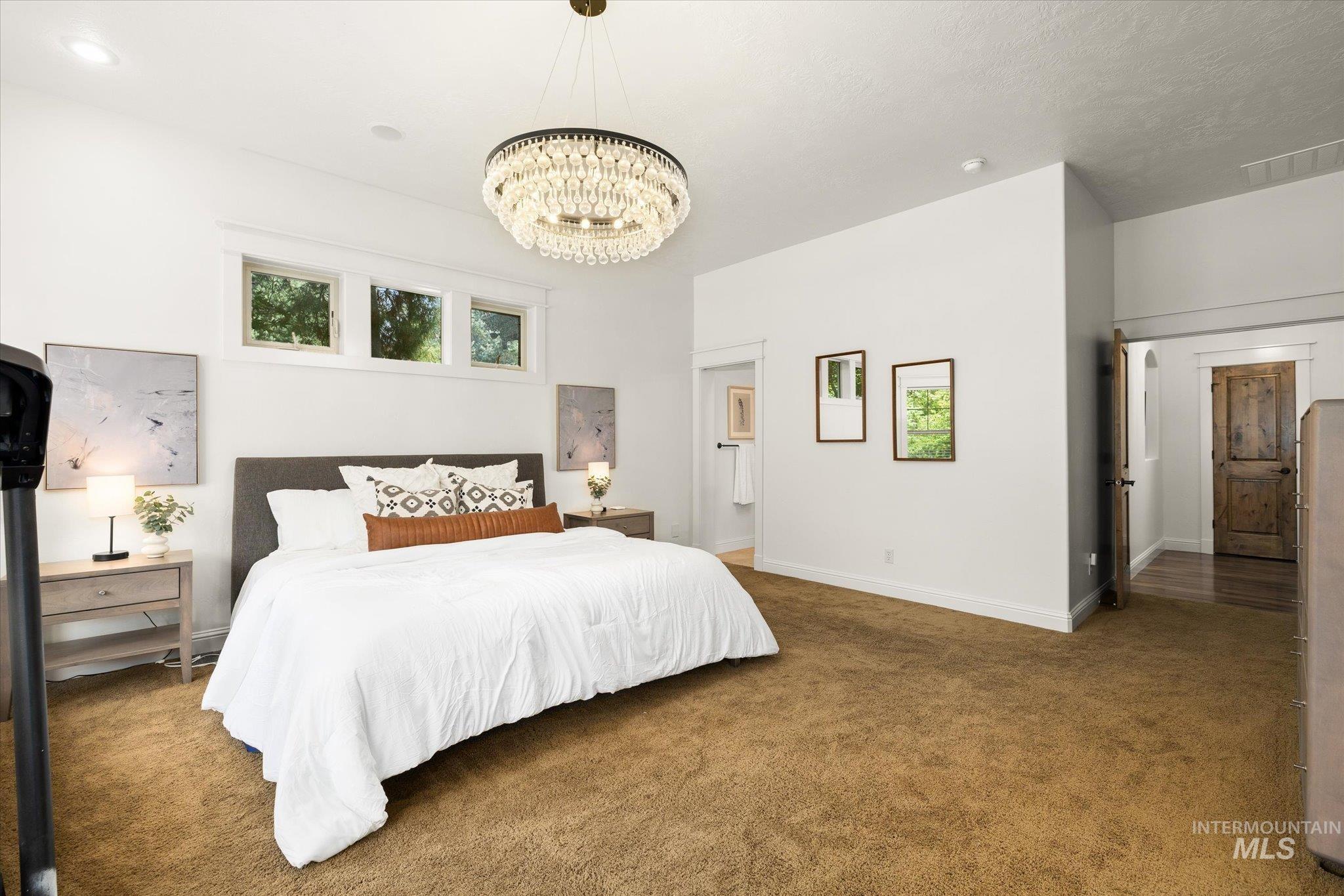 226 East Riversedge Drive Eagle, ID 83616 - Photo 23 of 50 Carpeted bedroom featuring baseboards and a chandelier