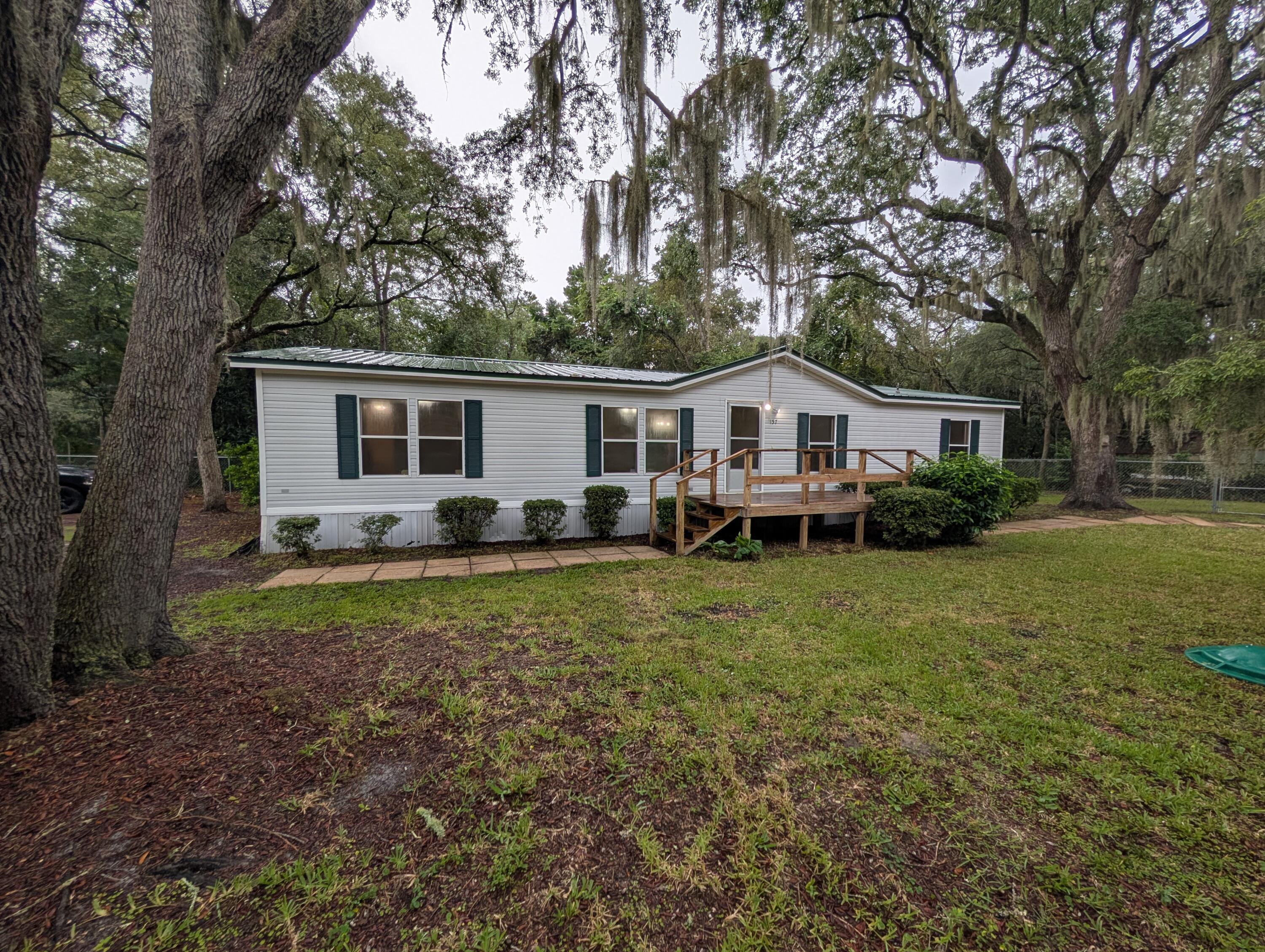 157 East Harborview Road Santa Rosa Beach, FL 32459 - Photo 1 of 27 a front view of house with yard and green space