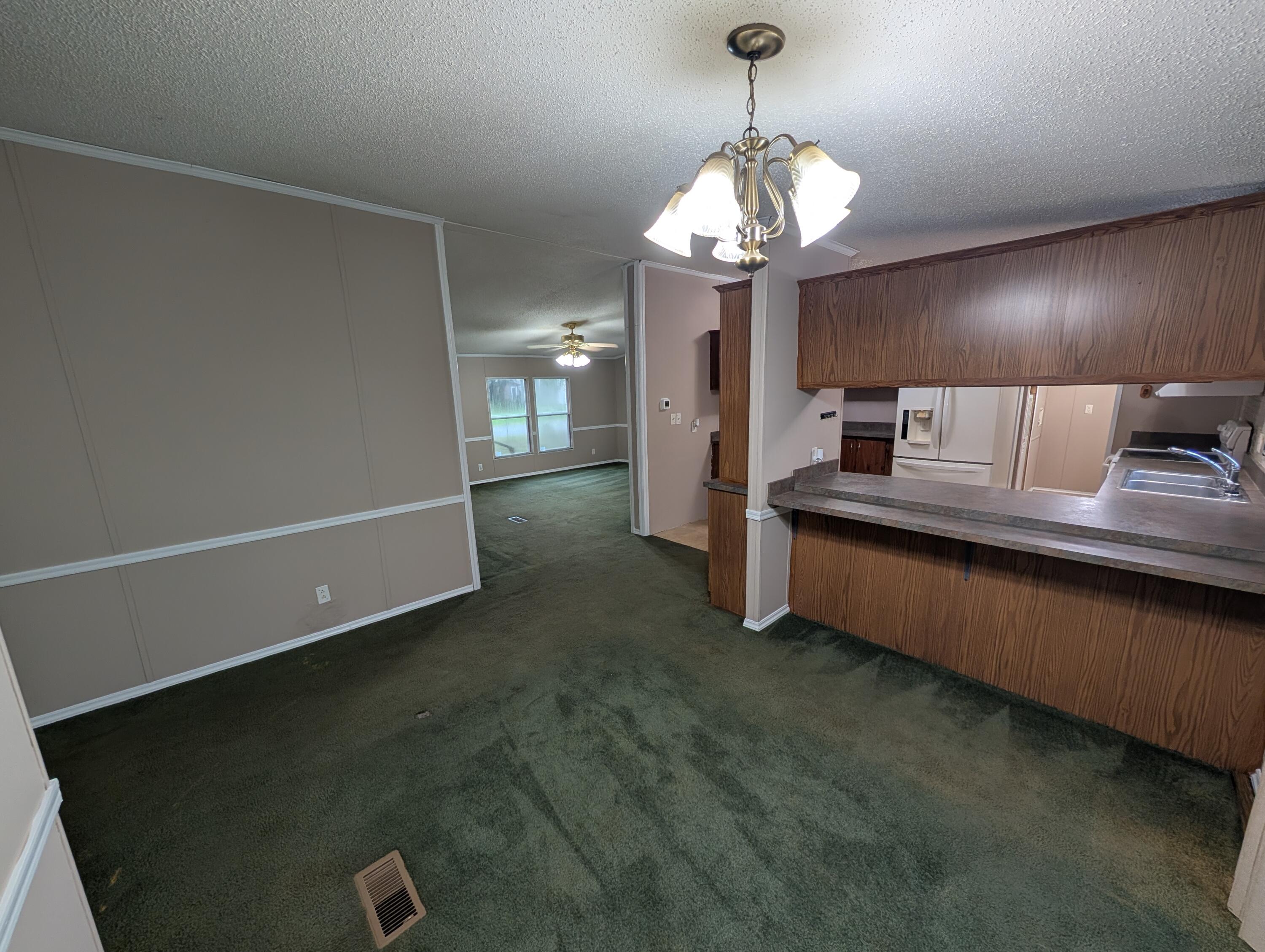 157 East Harborview Road Santa Rosa Beach, FL 32459 - Photo 12 of 27 a spacious bedroom with a bed and a chandelier