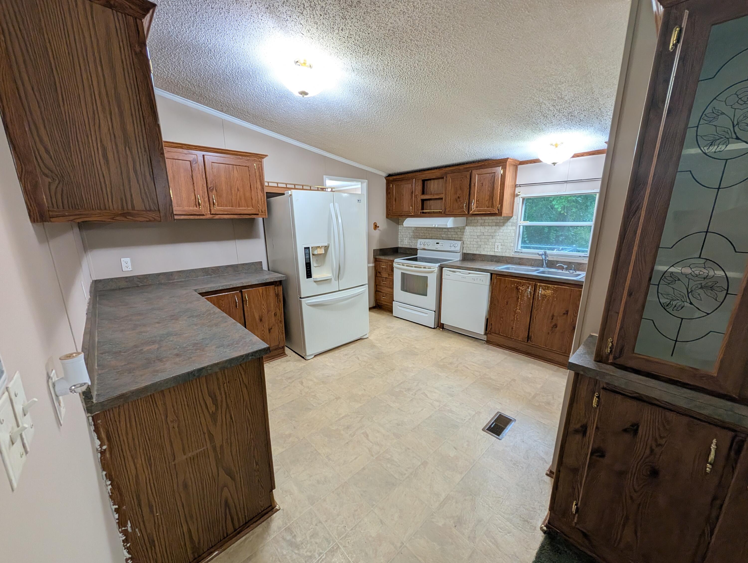 157 East Harborview Road Santa Rosa Beach, FL 32459 - Photo 13 of 27 a kitchen with stainless steel appliances granite countertop a sink stove and refrigerator