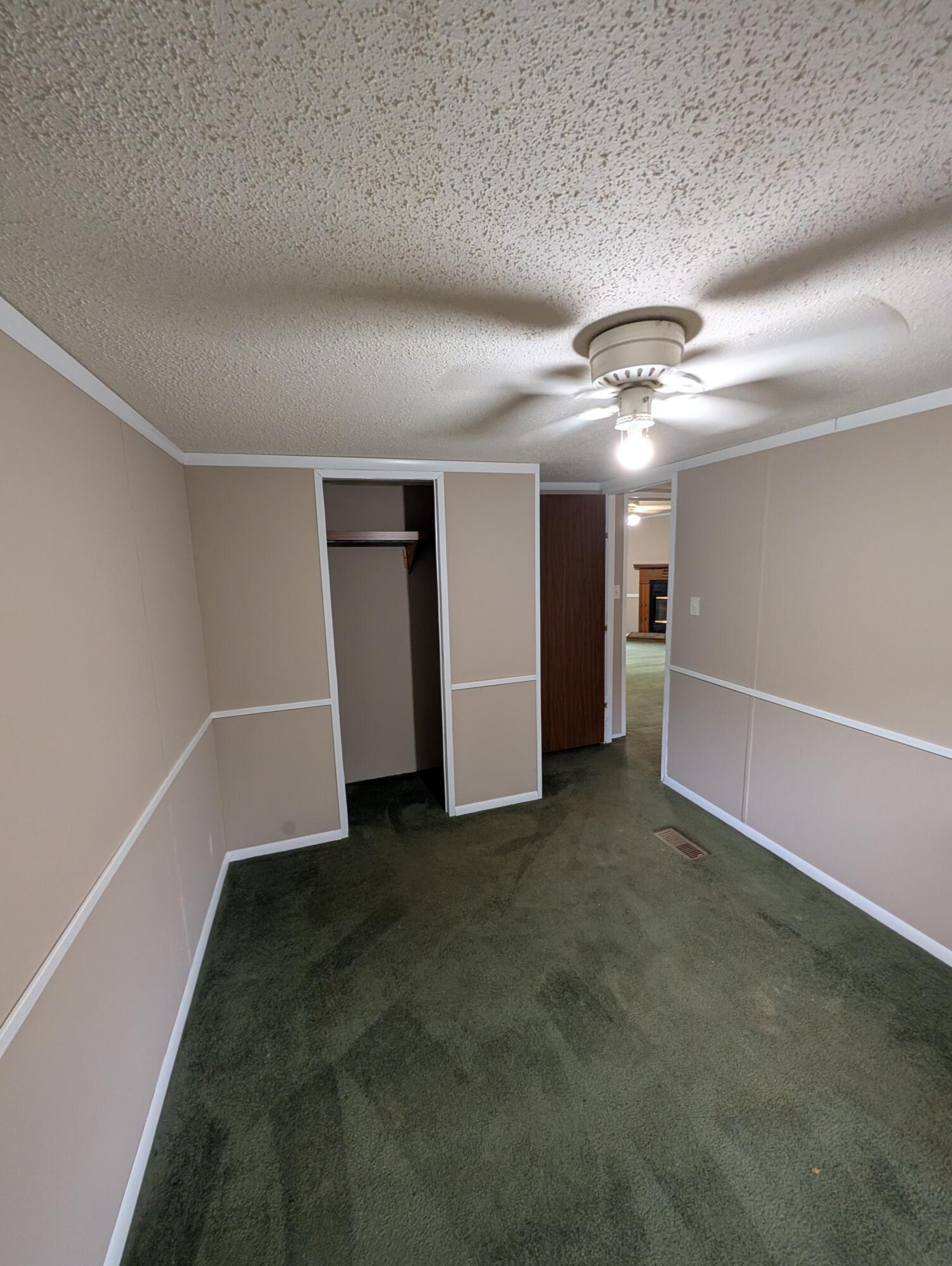 157 East Harborview Road Santa Rosa Beach, FL 32459 - Photo 23 of 27 an empty room with a ceiling fan and windows