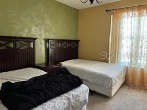 a bedroom with a bed and a night stand