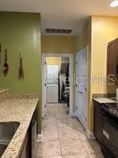 a kitchen with stainless steel appliances a sink stove and refrigerator