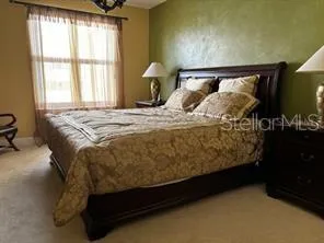 a bedroom with a bed and a night stand
