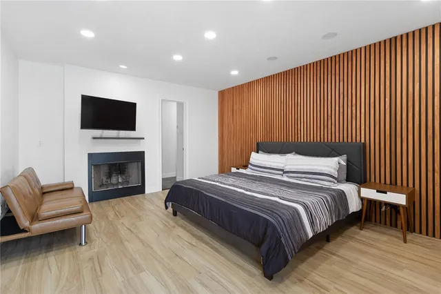 a spacious bedroom with a bed and a fireplace