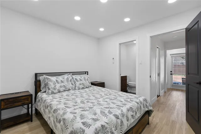 a bedroom with a bed and a large mirror