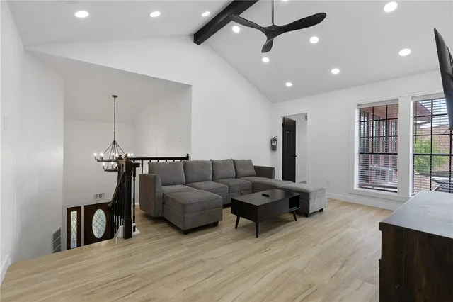a living room with furniture and a ceiling fan