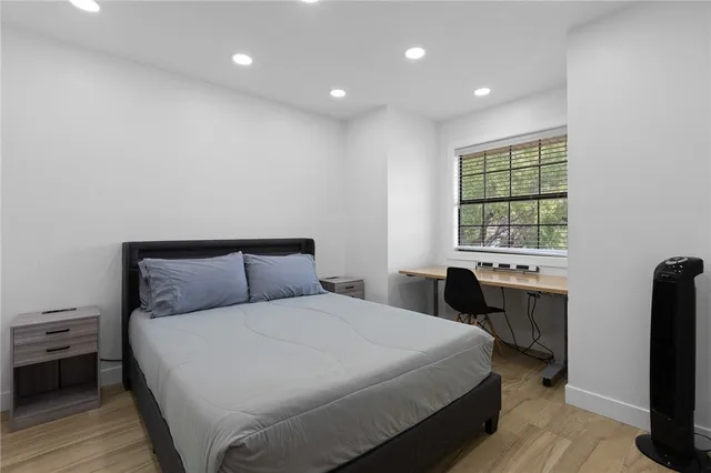 a bedroom with a bed and a window