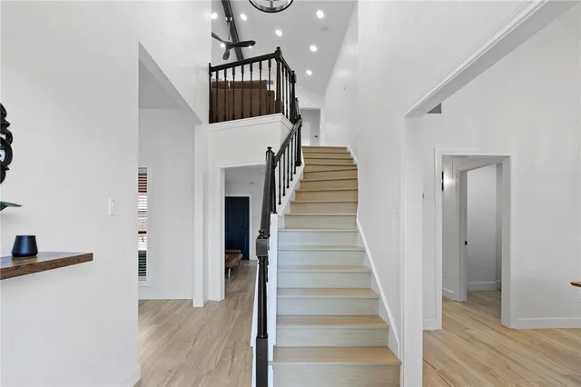 a view of entryway and hall with wooden floor
