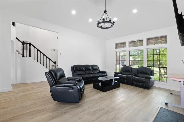 a living room with furniture and wooden floor