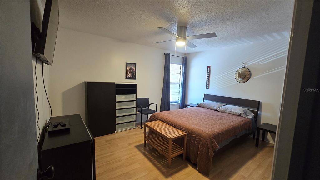 406 Lennox Road West Palm Harbor, FL 34683 - Photo 20 of 40 a bedroom with a bed and a flat tv screen on the dresser