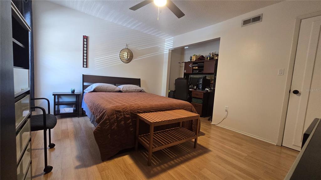 406 Lennox Road West Palm Harbor, FL 34683 - Photo 21 of 40 a bedroom with a bed and a chandelier