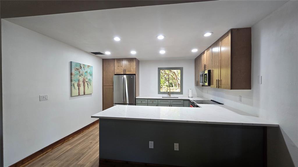 406 Lennox Road West Palm Harbor, FL 34683 - Photo 33 of 40 a kitchen with a sink and a refrigerator