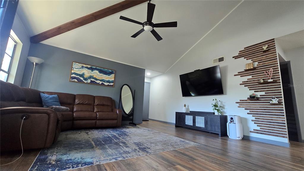 406 Lennox Road West Palm Harbor, FL 34683 - Photo 4 of 40 a living room with furniture and a flat screen tv