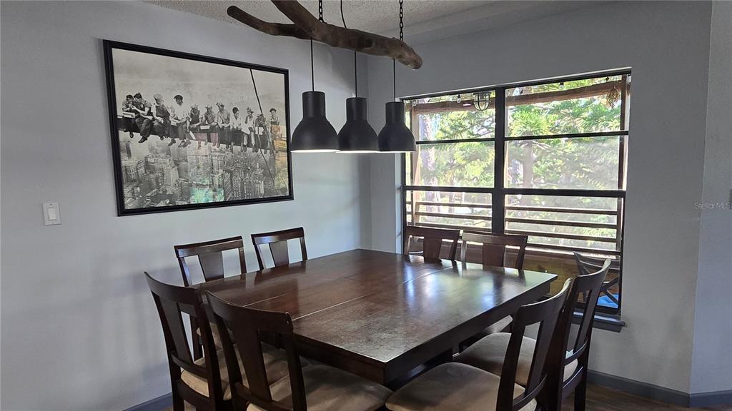 406 Lennox Road West Palm Harbor, FL 34683 - Photo 6 of 40 a view of a dining room with furniture a chandelier and wooden floor