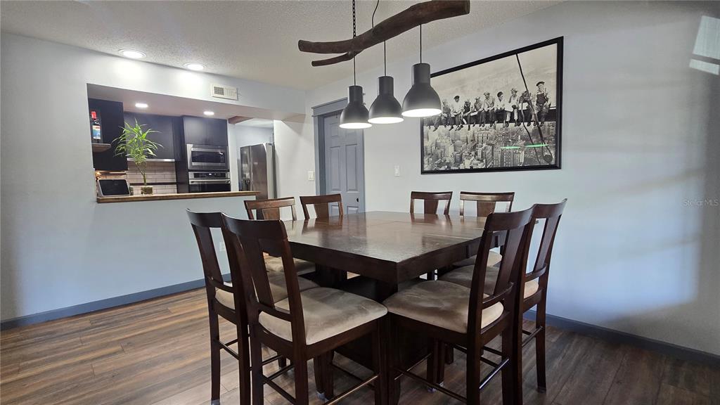 406 Lennox Road West Palm Harbor, FL 34683 - Photo 7 of 40 a view of a dining room with furniture and wooden floor