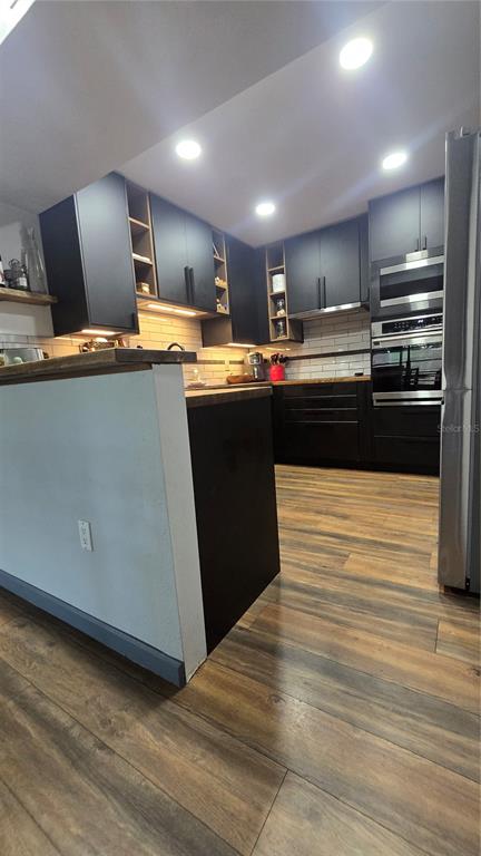406 Lennox Road West Palm Harbor, FL 34683 - Photo 9 of 40 a kitchen with stainless steel appliances kitchen island granite countertop a refrigerator stove top oven and sink