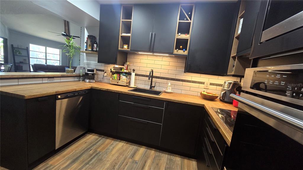 406 Lennox Road West Palm Harbor, FL 34683 - Photo 10 of 40 a kitchen with a sink stove and cabinets