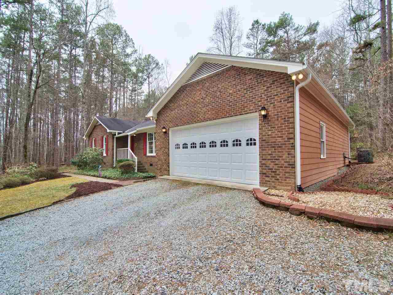 5701 Geoffrey Road Durham, NC 27712 - Photo 2 of 23 a view of a house with a yard and garage