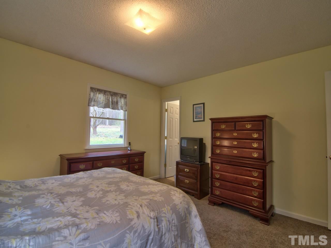5701 Geoffrey Road Durham, NC 27712 - Photo 12 of 23 a bedroom with a bed and furniture