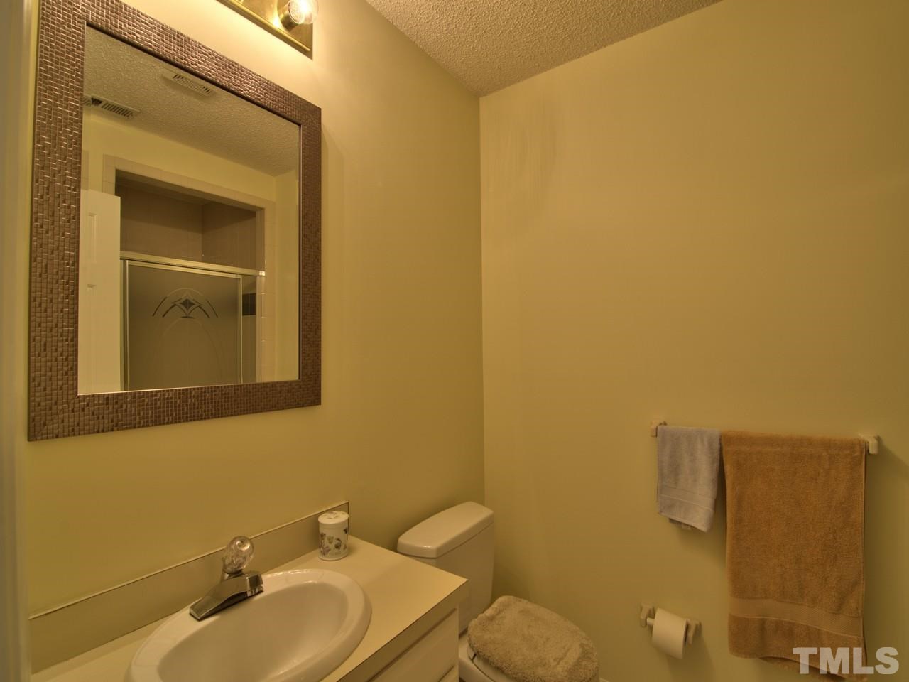 5701 Geoffrey Road Durham, NC 27712 - Photo 16 of 23 a bathroom with a sink and mirror
