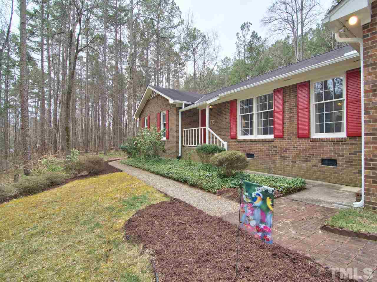 5701 Geoffrey Road Durham, NC 27712 - Photo 3 of 23 a front view of a house with a yard and potted plants