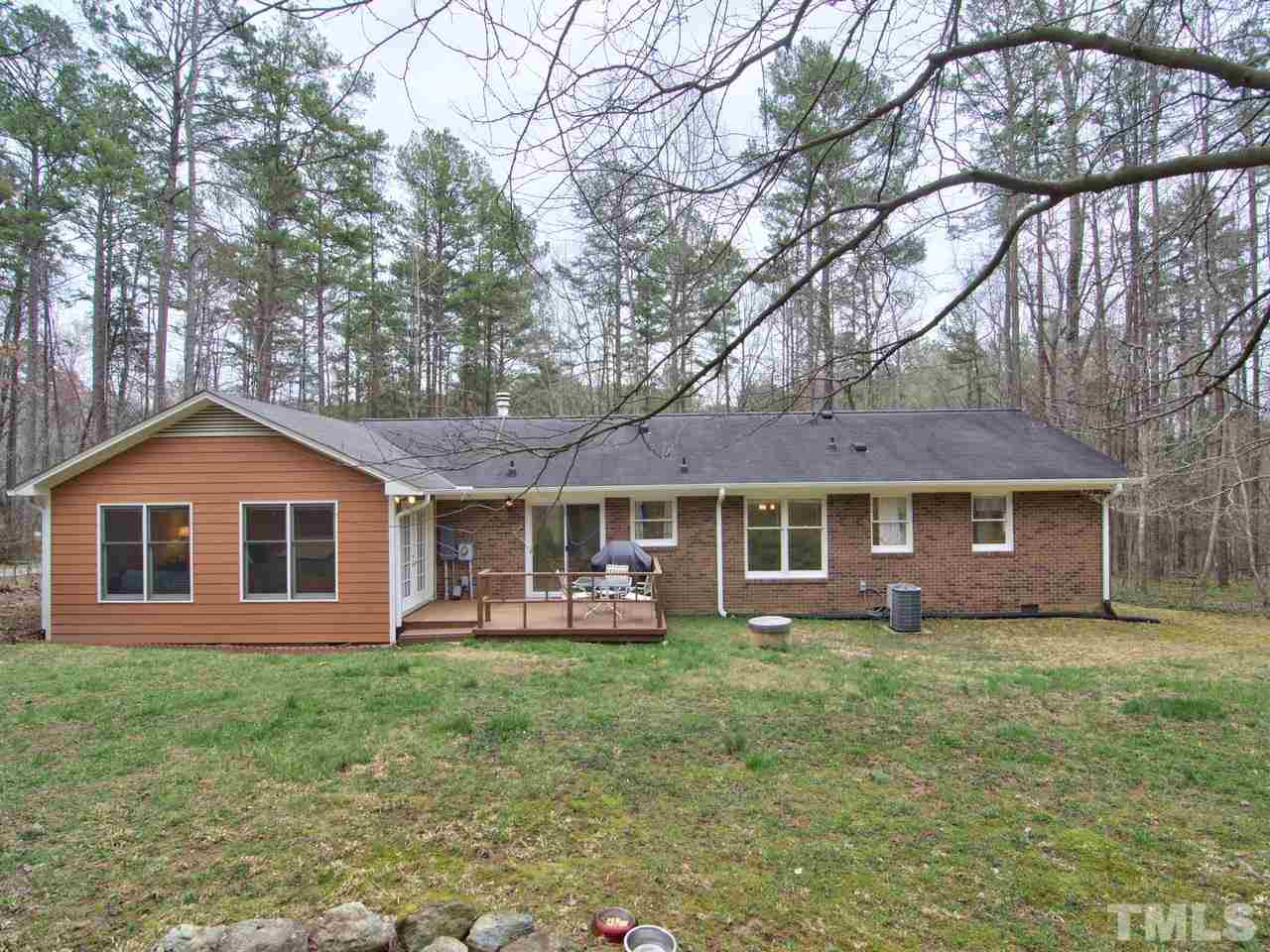 5701 Geoffrey Road Durham, NC 27712 - Photo 22 of 23 a front view of a house with a yard and trees