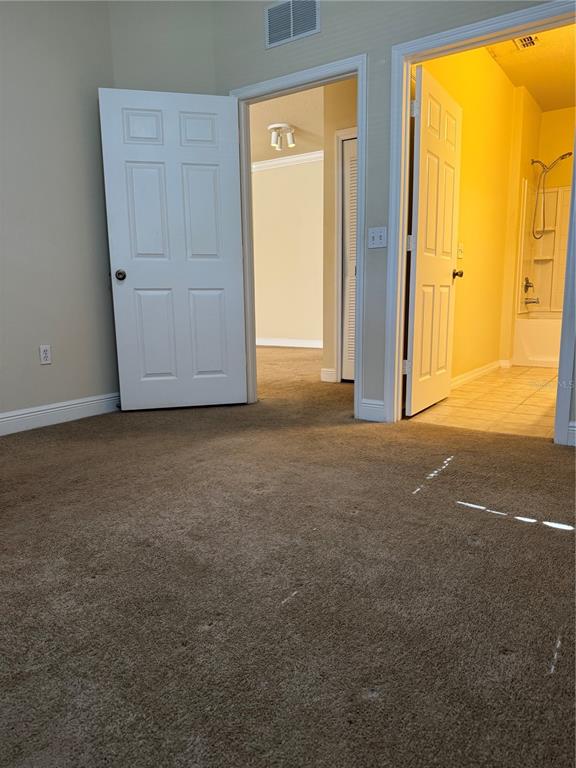 1315 Eastern Pecan Place, Unit 107 Winter Garden, FL 34787 - Photo 8 of 10 an empty room with windows