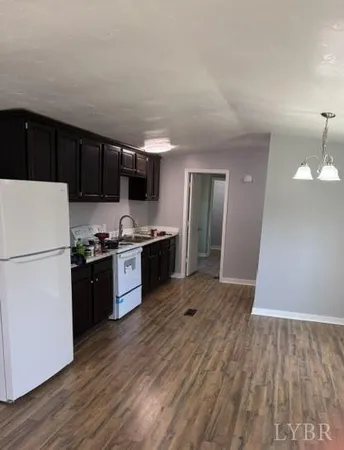 a kitchen with a refrigerator and a stove top oven