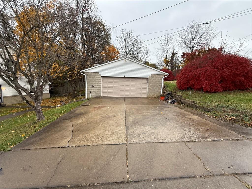 1006-1008 Olive Avenue Natrona Heights, PA 15065 - Photo 22 of 26 a view of a house with a yard and large tree