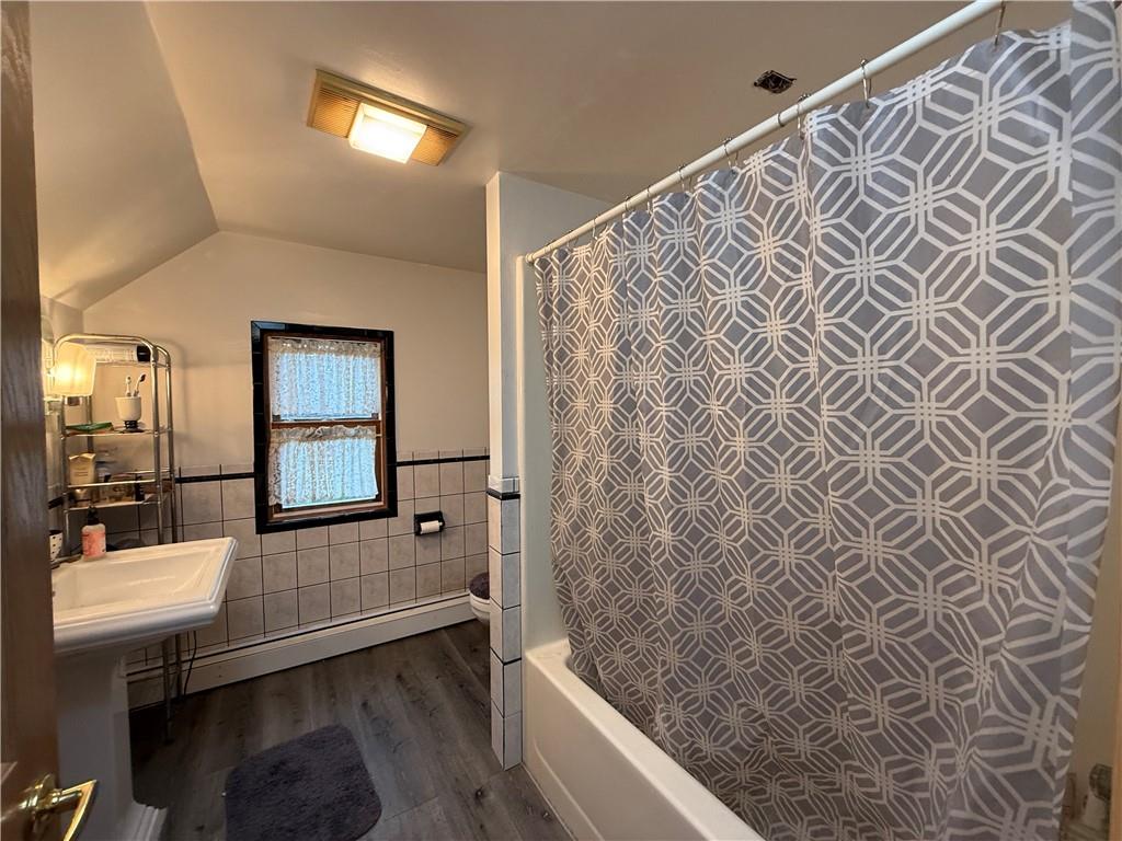 1006-1008 Olive Avenue Natrona Heights, PA 15065 - Photo 9 of 26 a bathroom with a bathtub and a shower