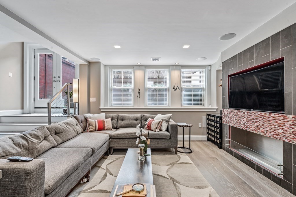 98 Waltham Street, Unit 1 Boston, MA 02118 - Photo 2 of 26 a living room with furniture and a flat screen tv